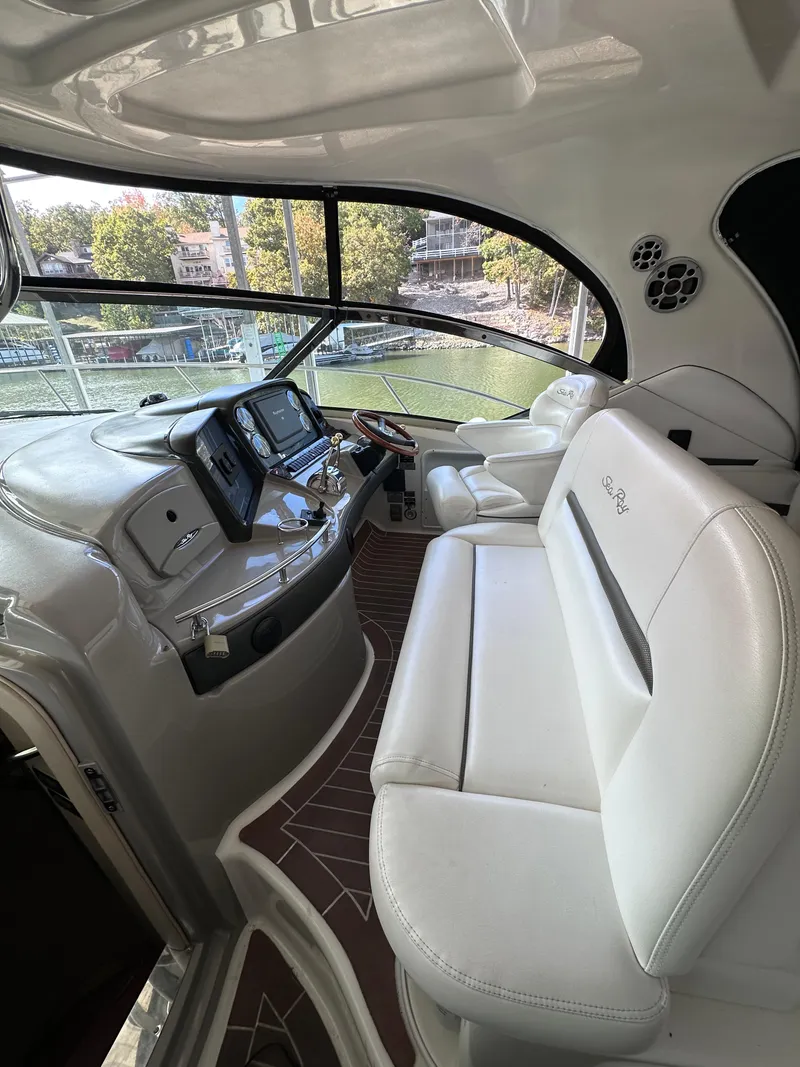 Slide: The Image of Interior of 2007 Sea Ray 44 Sundancer yacht with modern helm and white seating. - 11
