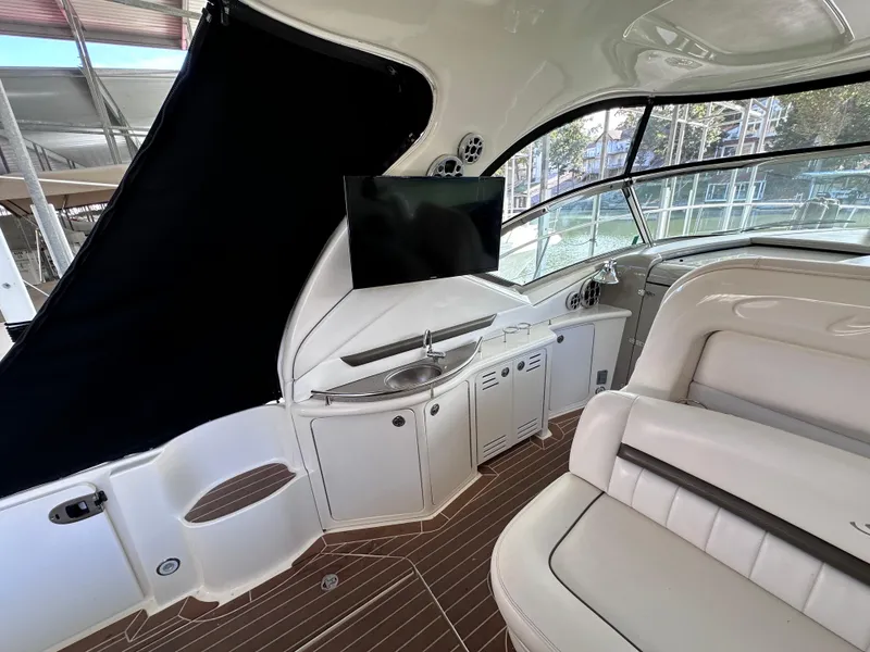 Slide: The Image of Interior of 2007 Sea Ray 44 Sundancer yacht with seating, TV, and kitchenette. - 14