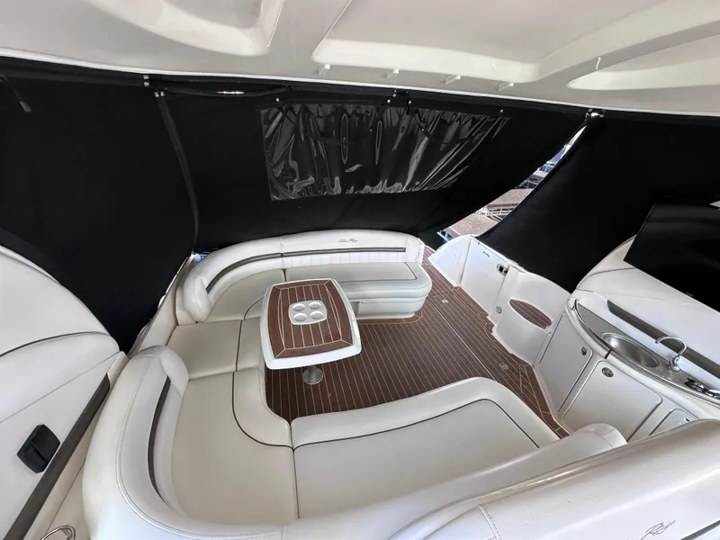 Slide: The Image of Luxurious interior of 2007 Sea Ray 44 Sundancer yacht with white seating and wood table. - 16