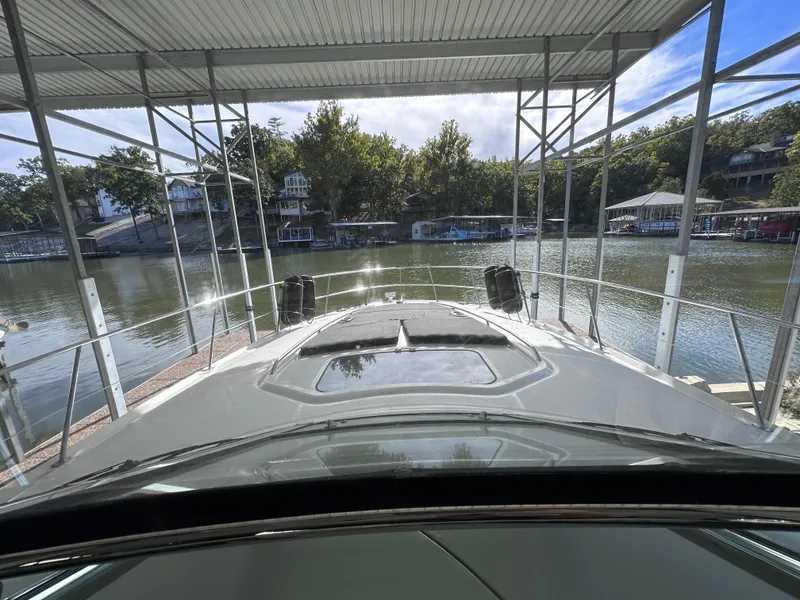 Slide: The Image of 2007 Sea Ray 44 Sundancer docked at a scenic lakeside marina. - 19