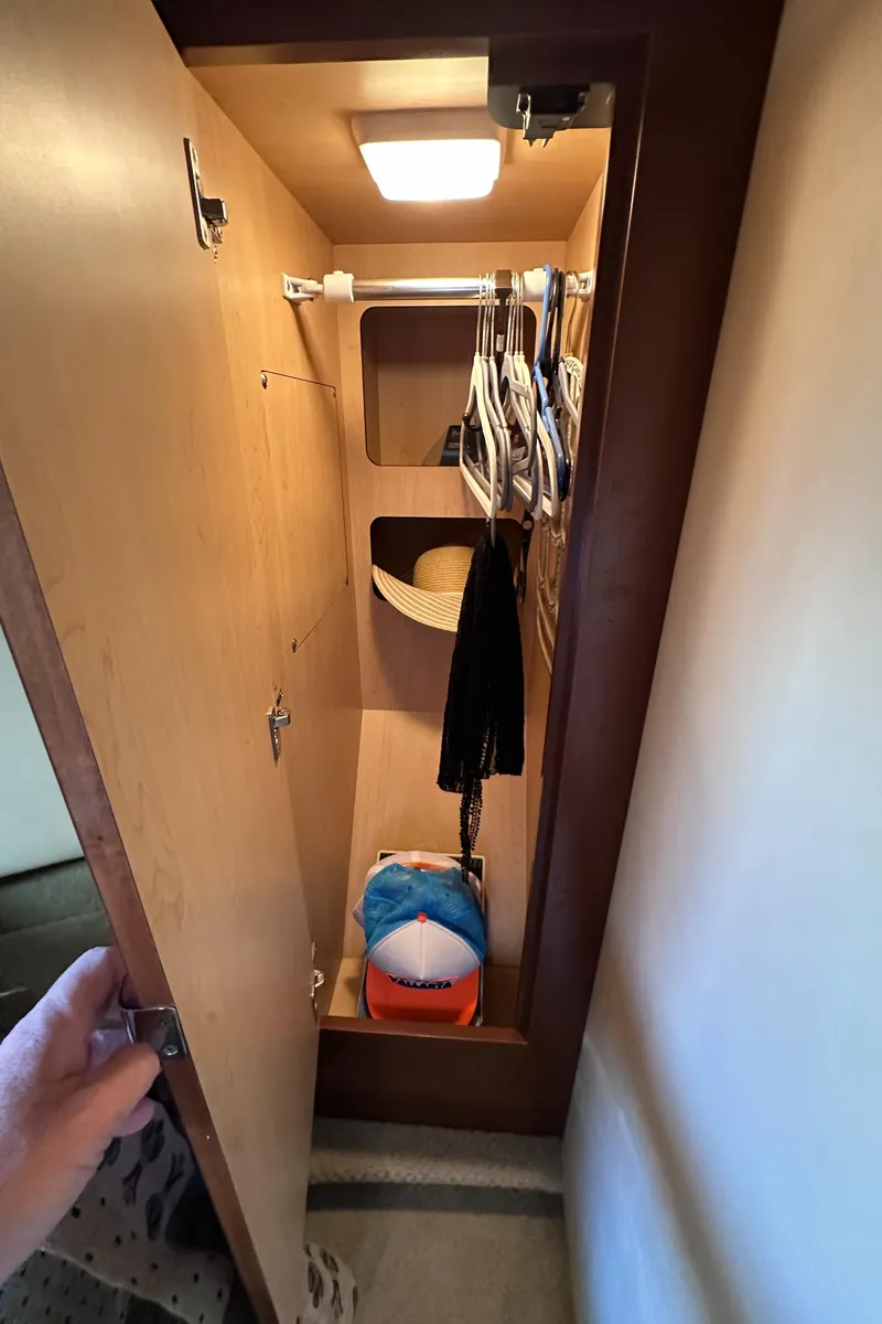 Slide: The Image of Closet interior on 2007 Sea Ray 44 Sundancer yacht with hangers and shelves. - 26