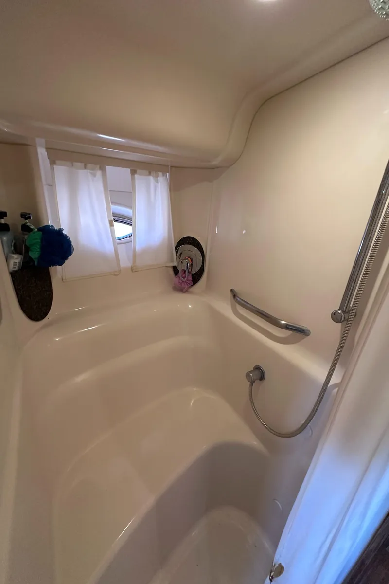 Slide: The Image of 2007 Sea Ray 44 Sundancer bathroom with shower, curtain, and handrail. - 27