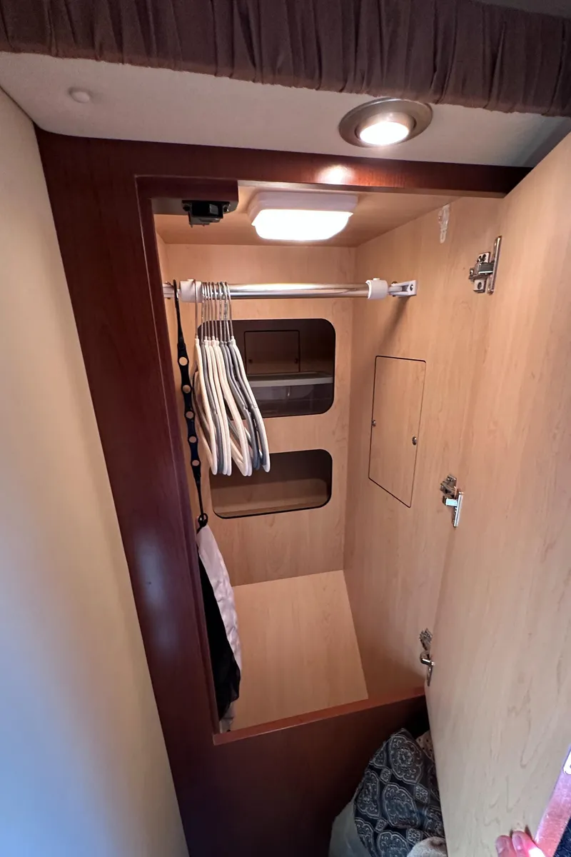 Slide: The Image of 2007 Sea Ray 44 Sundancer closet interior with hangers and shelves. - 29