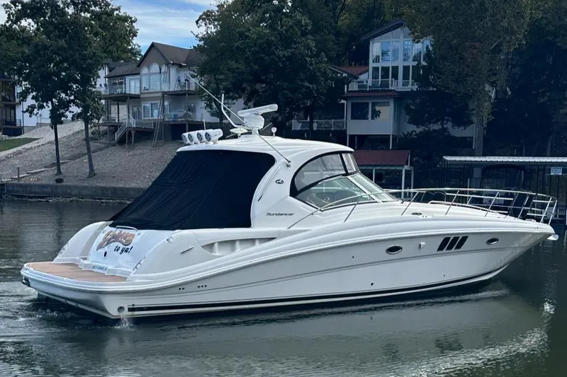 Slide: The Image of 2007 Sea Ray 44 Sundancer yacht on a calm lake near waterfront homes. - 6