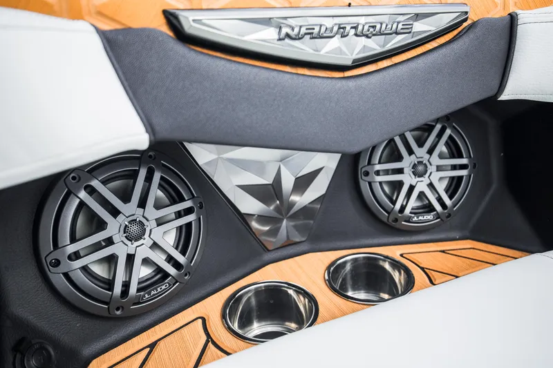 Slide: The Image of 2025 Nautique Ski boat interior with premium speakers and cup holders. - 13