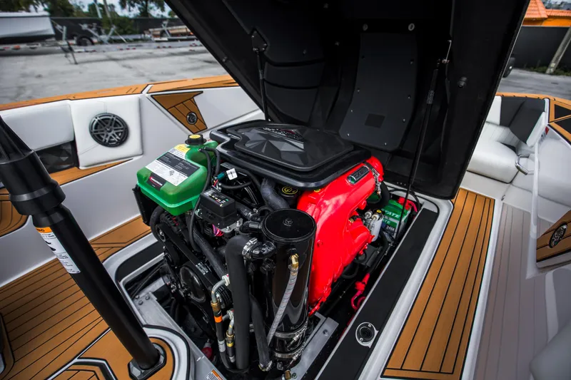 Slide: The Image of 2025 Nautique Ski boat engine compartment with open hood, showcasing detailed engine components. - 17