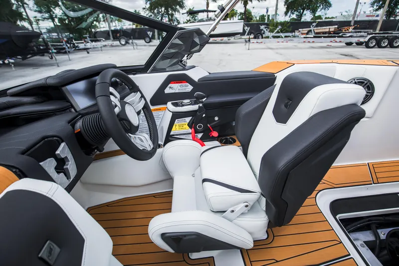 Slide: The Image of 2025 Nautique Ski boat interior with modern steering and seating design. - 18
