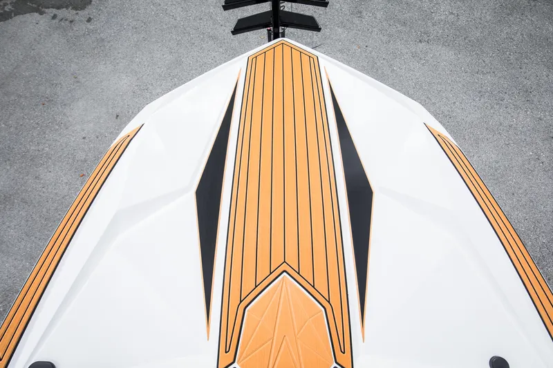 Slide: The Image of 2025 Nautique Ski boat deck with sleek orange and black design. - 19