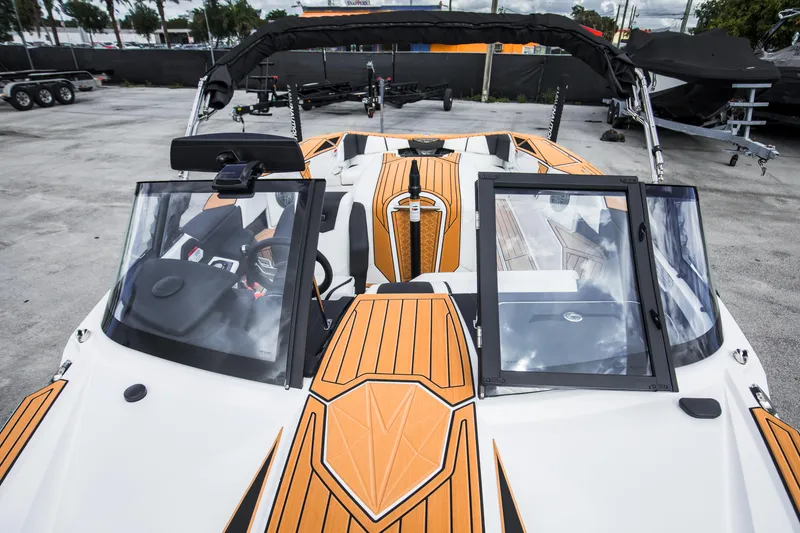 Slide: The Image of 2025 Nautique Ski boat with orange accents, featuring a sleek design and modern dashboard. - 20