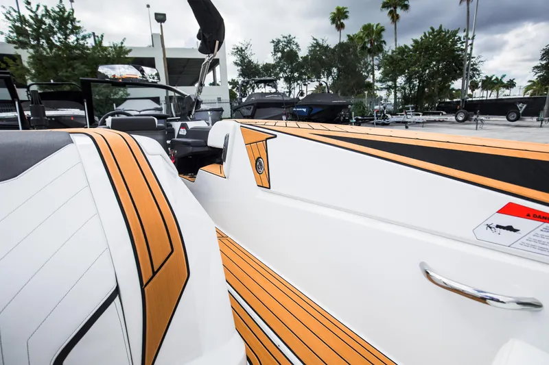 Slide: The Image of 2025 Nautique Ski boat interior with sleek design and wood accents. - 25