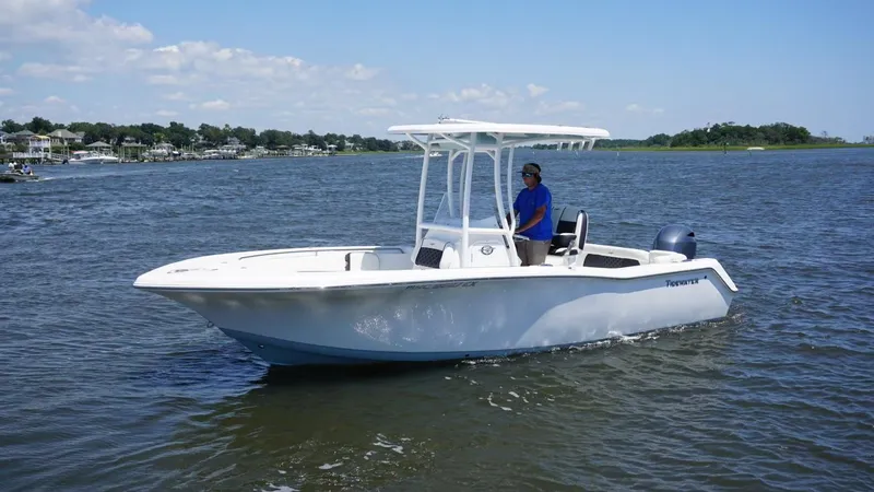 Slide: The Image of 2021 Tidewater 220 LXF boat cruising on a calm lake. - 1