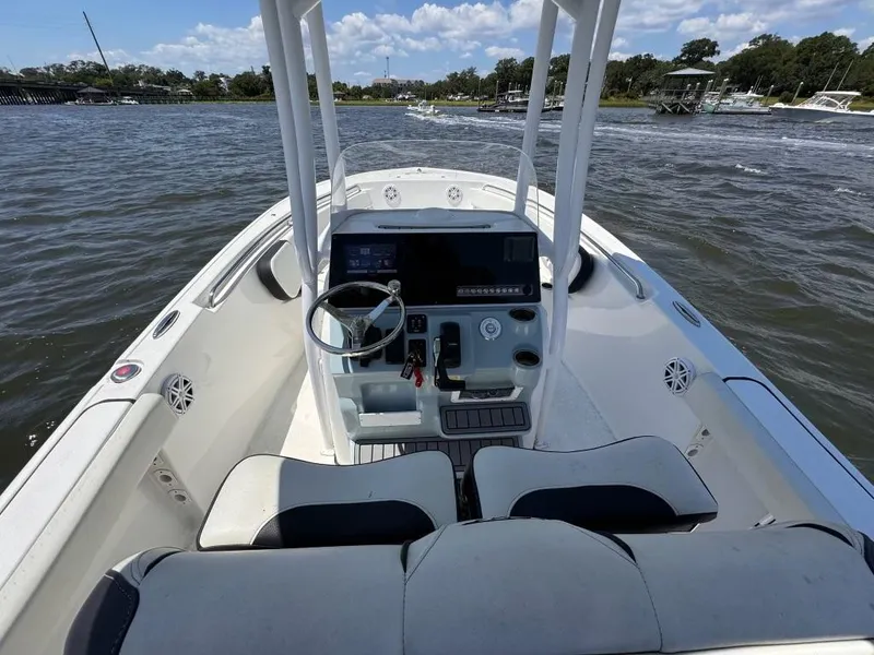 Slide: The Image of 2021 Tidewater 220 LXF boat interior with steering console on open water. - 10