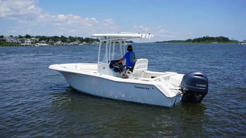 Slide: The Image of 2021 Tidewater 220 LXF boat on water with Yamaha outboard motor. - 3
