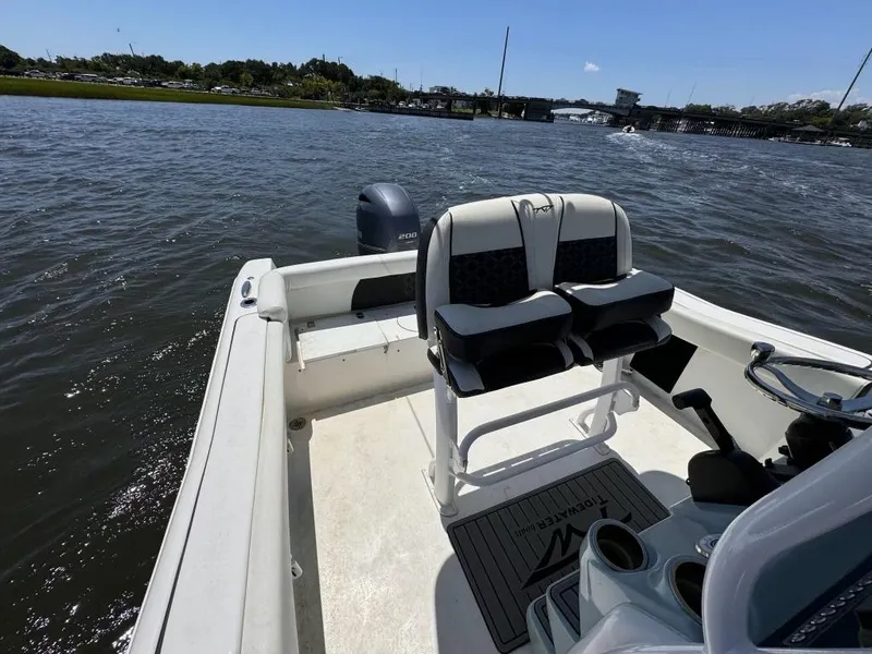 Slide: The Image of 2021 Tidewater 220 LXF boat on water, featuring dual seating and steering console. - 7