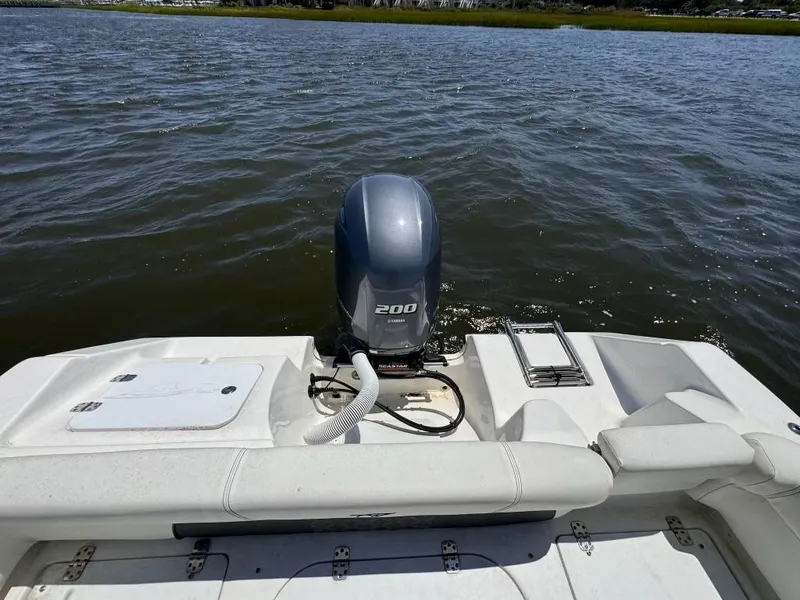 Slide: The Image of 2021 Tidewater 220 LXF boat with 200 HP outboard motor on a calm lake. - 9