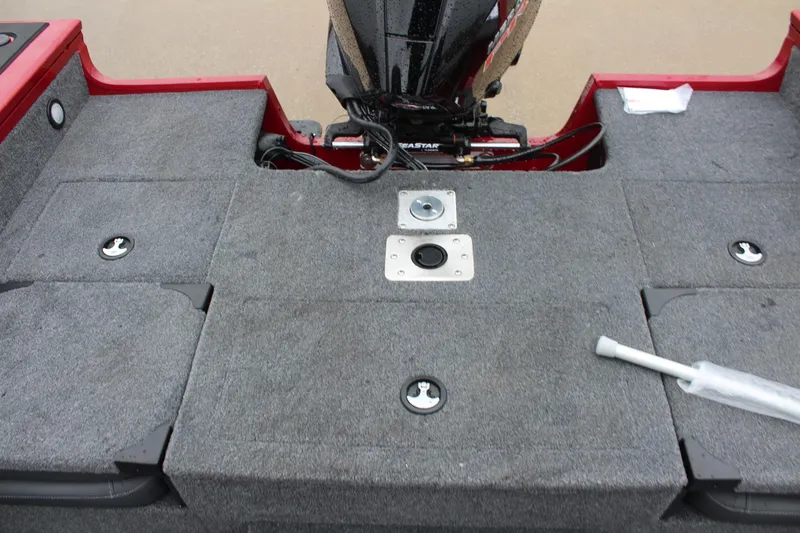 Slide: The Image of 2025 Tracker Targa V-18 Combo boat deck with motor and storage compartments. - 13