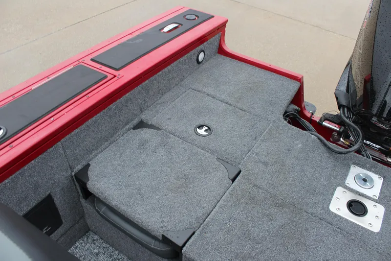 Slide: The Image of 2025 Tracker Targa V-18 Combo boat interior with gray carpet and red trim. - 17