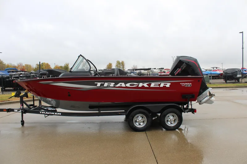 Slide: The Image of 2025 Tracker Targa V-18 Combo boat on trailer, red and silver design. - 2