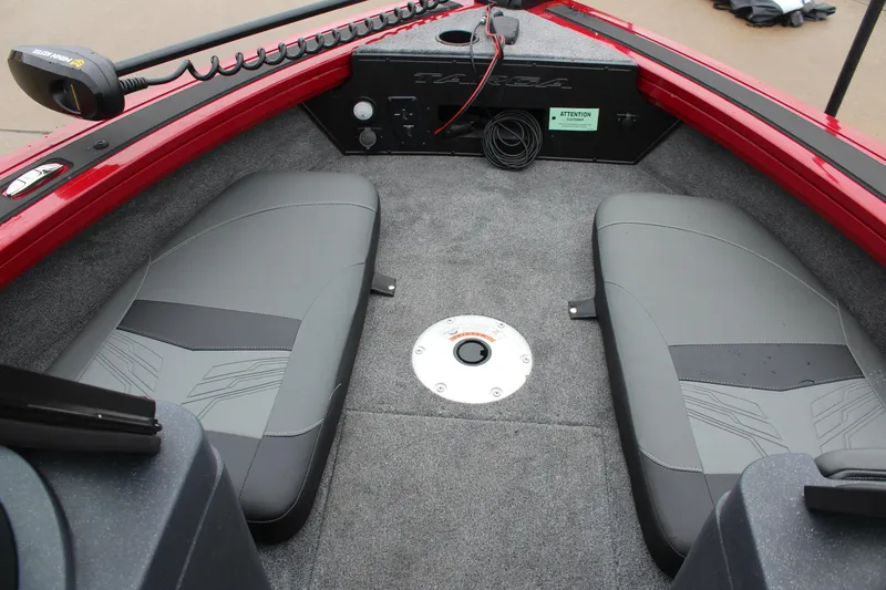 Slide: The Image of 2025 Tracker Targa V-18 Combo boat interior with gray seating and red trim. - 23