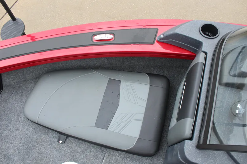 Slide: The Image of 2025 Tracker Targa V-18 Combo boat interior with gray seating and red trim. - 25