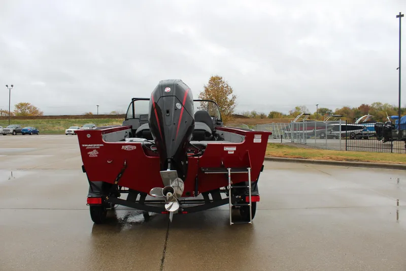 Slide: The Image of 2025 Tracker Targa V-18 Combo boat, rear view, parked on wet pavement. - 3