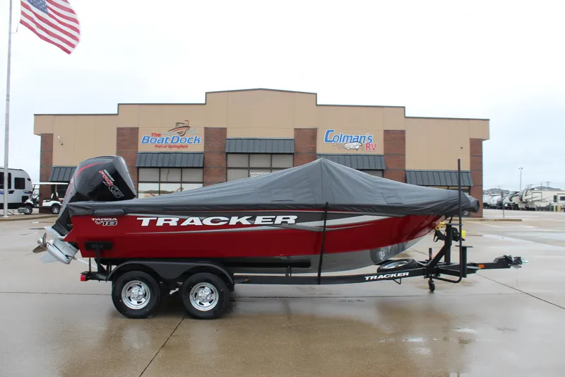 Slide: The Image of 2025 Tracker Targa V-18 Combo boat with cover, parked outside dealership. - 4