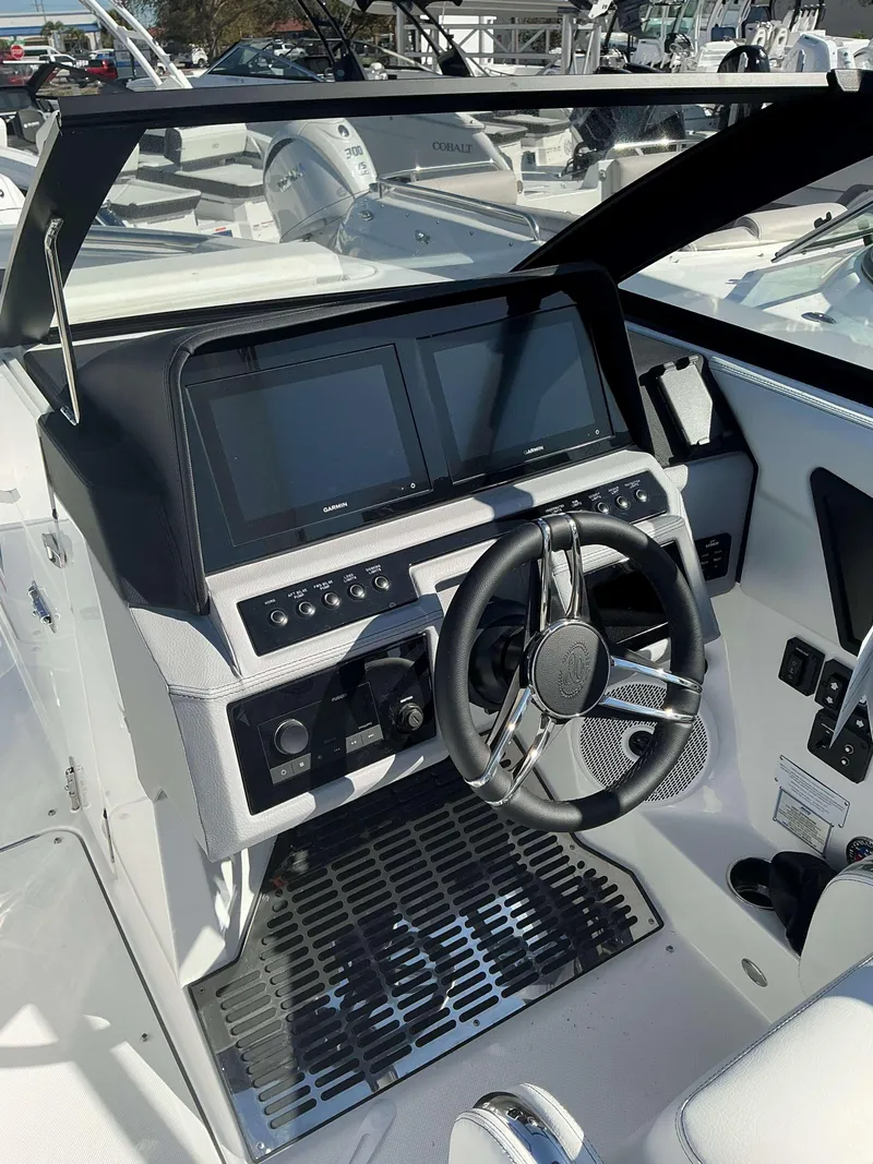 Slide: The Image of 2025 Cobalt R8 boat dashboard with dual screens and modern steering wheel. - 10