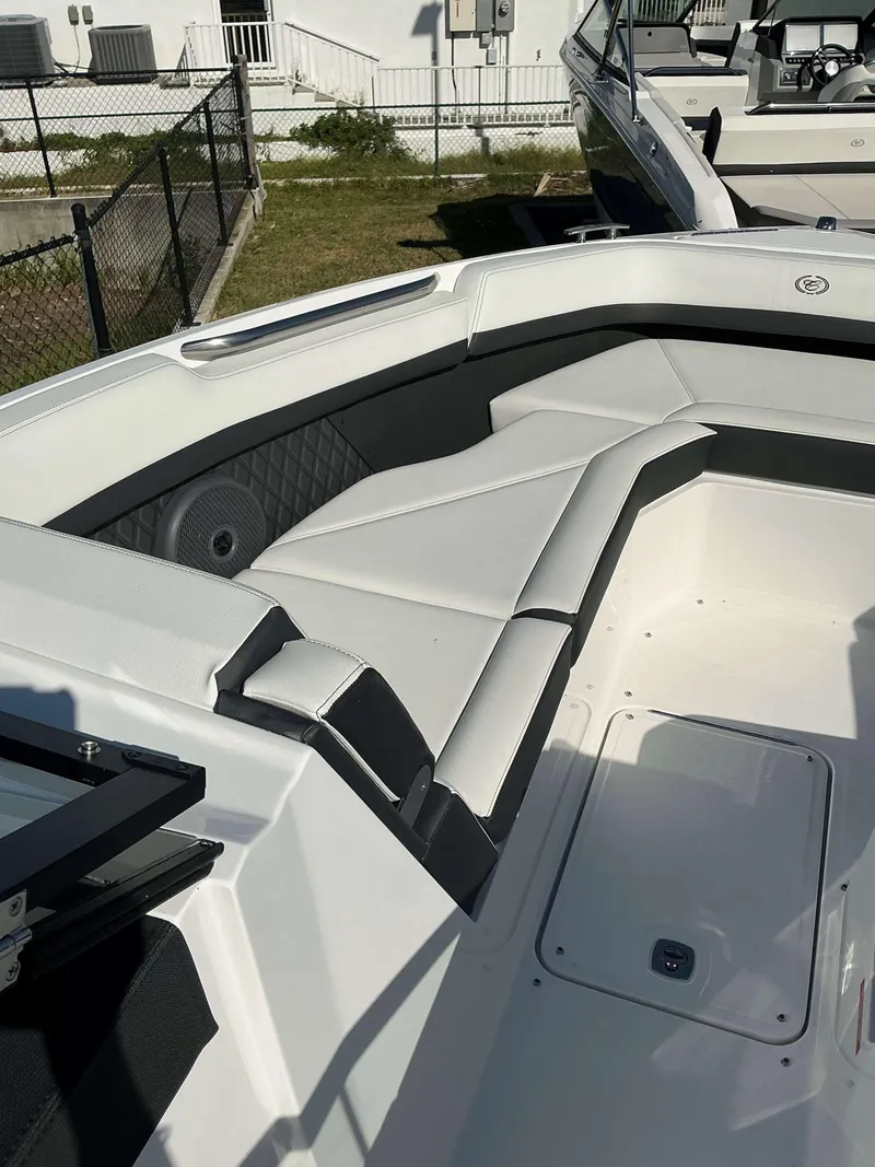 Slide: The Image of 2025 Cobalt R8 boat interior with white cushioned seating and modern design. - 11