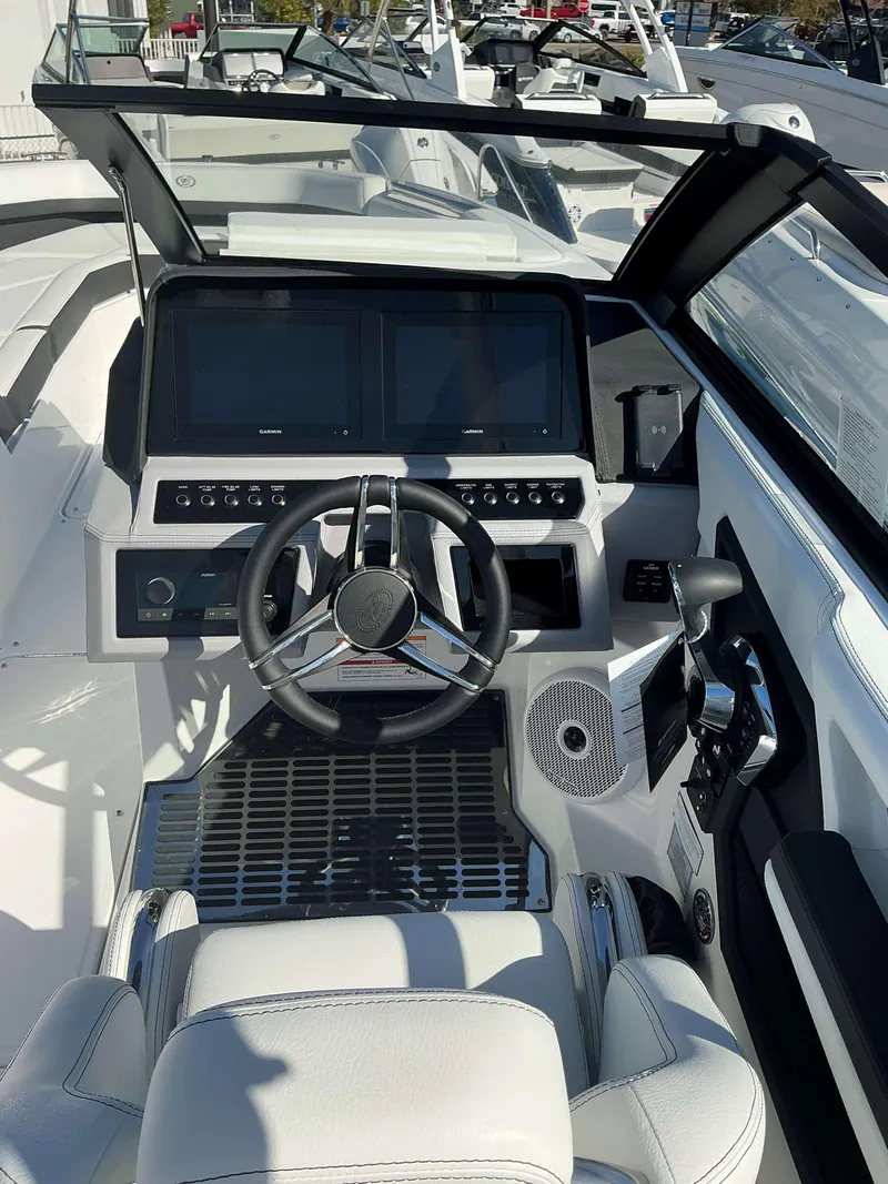 Slide: The Image of 2025 Cobalt R8 boat cockpit with modern steering and dual screens. - 12