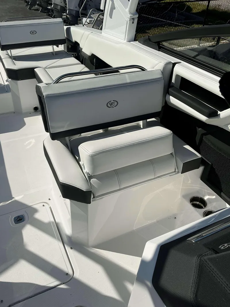 Slide: The Image of 2025 Cobalt R8 boat interior with white cushioned seating and sleek design. - 9