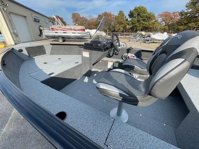 Slide: The Image of 2025 Lund 1650 Rebel XL SS boat interior with seating and steering console. - 11