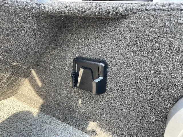 Slide: The Image of 2025 Lund 1650 Rebel XL SS interior detail with carpeted finish and mounted accessory. - 12