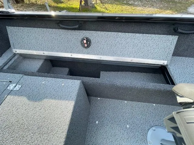 Slide: The Image of 2025 Lund 1650 Rebel XL SS boat interior with gray textured flooring. - 15