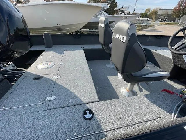 Slide: The Image of 2025 Lund 1650 Rebel XL SS boat interior with two seats and storage compartments. - 20