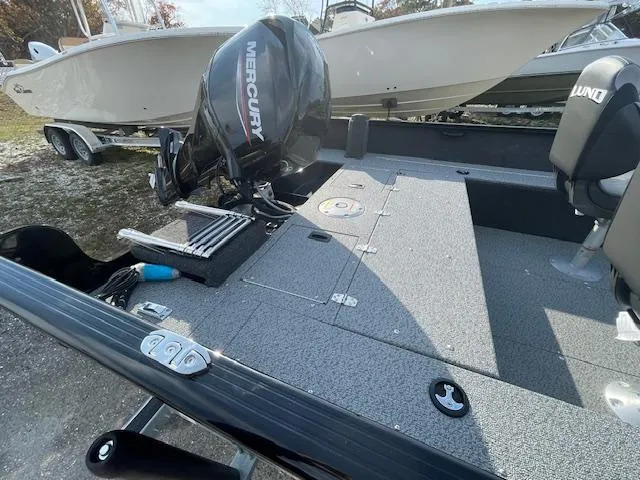 Slide: The Image of 2025 Lund 1650 Rebel XL SS boat with Mercury engine, parked on a trailer. - 21