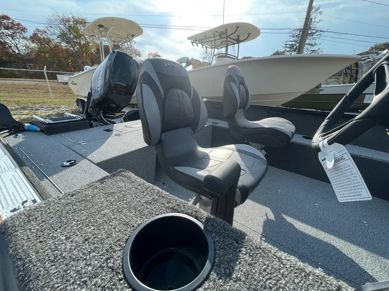 Slide: The Image of 2025 Lund 1650 Rebel XL SS boat interior with seating and cup holder. - 23