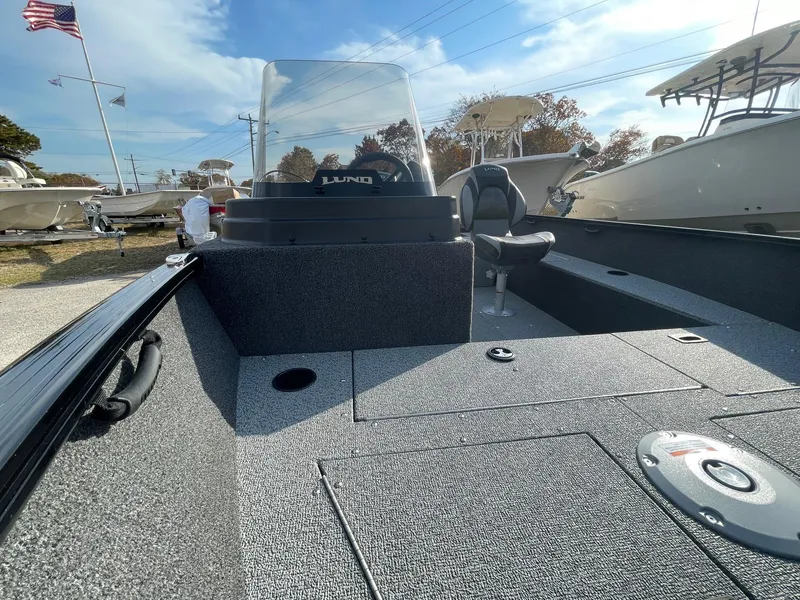 Slide: The Image of 2025 Lund 1650 Rebel XL SS boat, spacious deck, sleek design, outdoor display. - 24