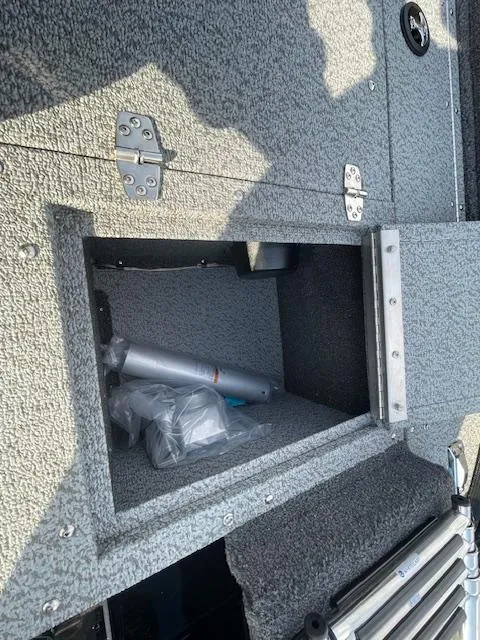 Slide: The Image of Open storage compartment in 2025 Lund 1650 Rebel XL SS boat. - 28