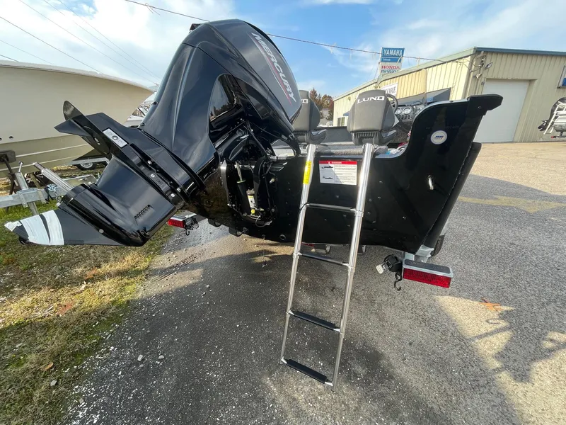 Slide: The Image of 2025 Lund 1650 Rebel XL SS boat with ladder and powerful outboard motor. - 6