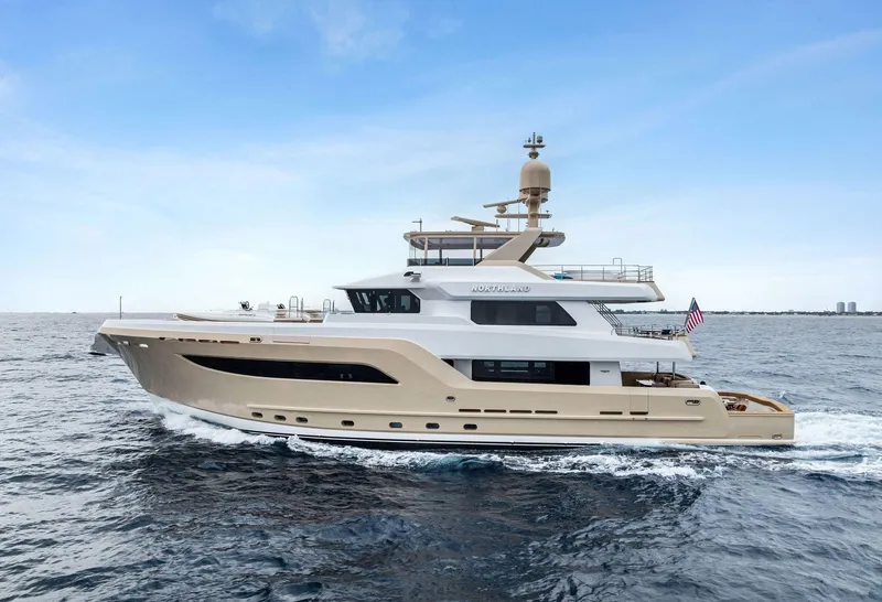 Slide: The Image of 2017 Burger 104 Motor Yacht cruising on open water under clear skies. - 1