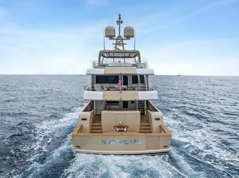 Slide: The Image of 2017 Burger 104 Motor Yacht cruising on open sea, rear view. - 11