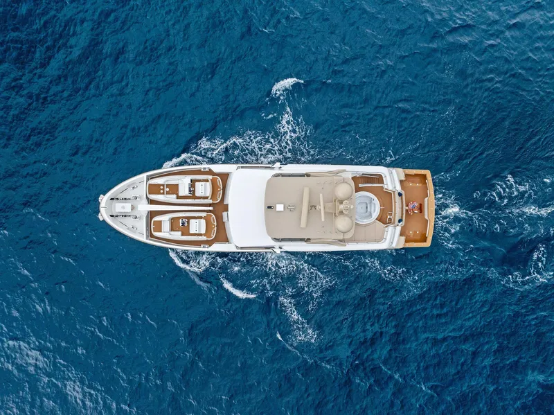 Slide: The Image of Aerial view of 2017 Burger 104 Motor Yacht cruising on blue ocean waters. - 15