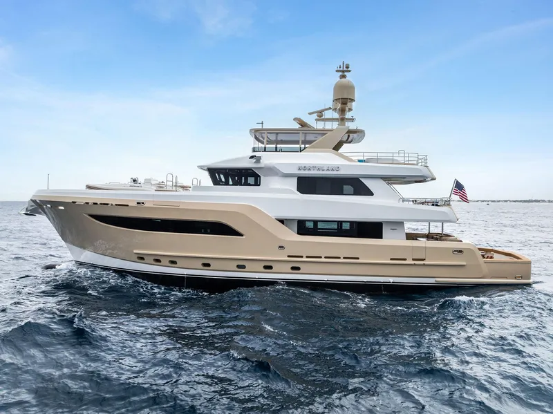 Slide: The Image of 2017 Burger 104 Motor Yacht cruising on open sea under clear blue sky. - 18