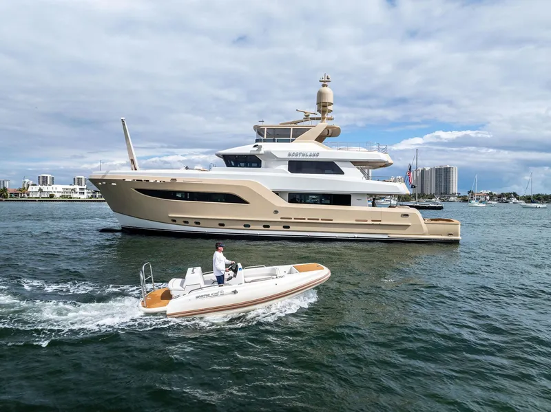 Slide: The Image of Luxurious 2017 Burger 104 Motor Yacht cruising alongside a small boat on a sunny day. - 2