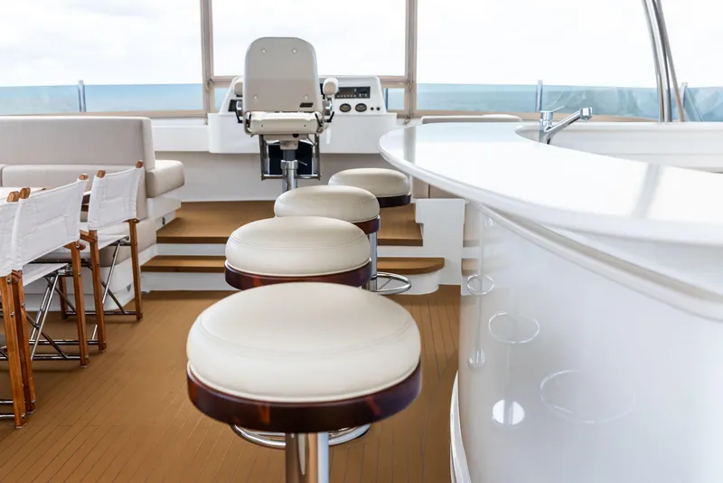 Slide: The Image of Luxurious interior of 2017 Burger 104 Motor Yacht with bar stools and helm station. - 22
