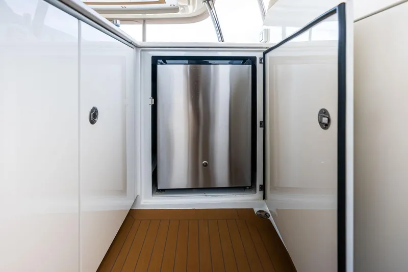 Slide: The Image of Stainless steel refrigerator on 2017 Burger 104 Motor Yacht, open cabinet doors. - 26
