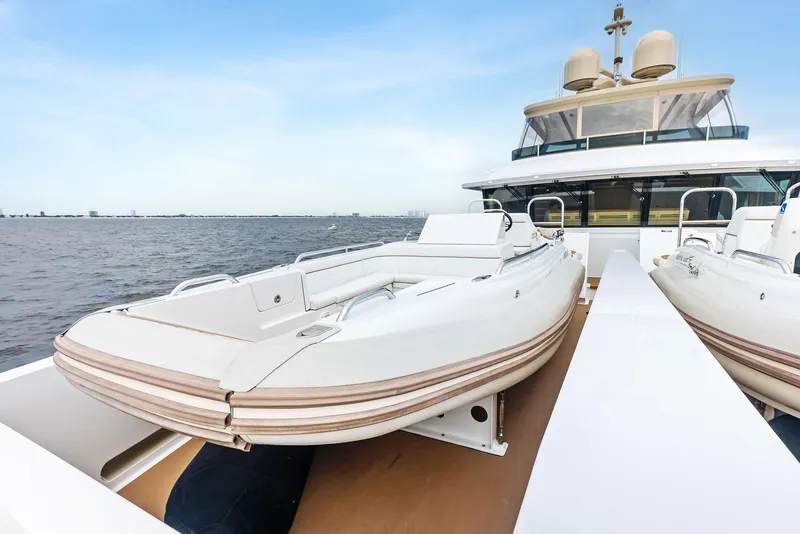 Slide: The Image of 2017 Burger 104 Motor Yacht with tender on deck, cruising on open water. - 30