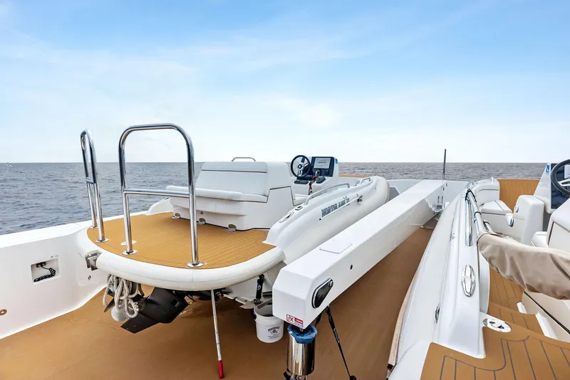 Slide: The Image of 2017 Burger 104 Motor Yacht deck with tender, ocean view, and clear sky. - 33