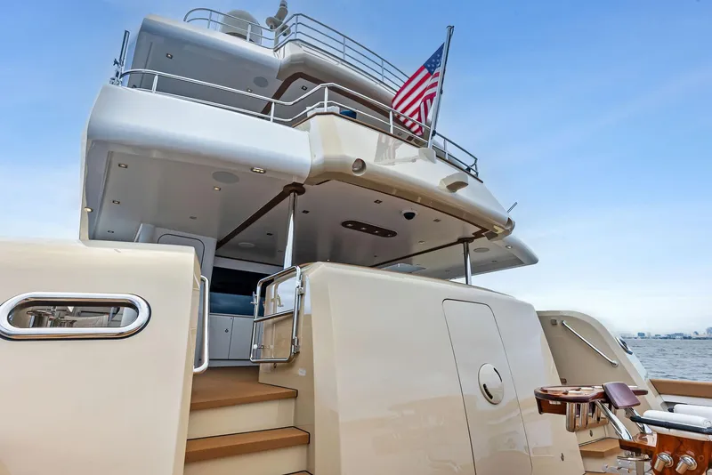 Slide: The Image of Luxurious 2017 Burger 104 Motor Yacht with American flag, docked on calm waters. - 37