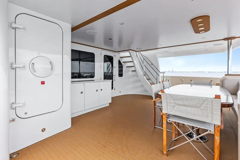 Slide: The Image of Spacious deck of 2017 Burger 104 Motor Yacht with dining area and stairs. - 42